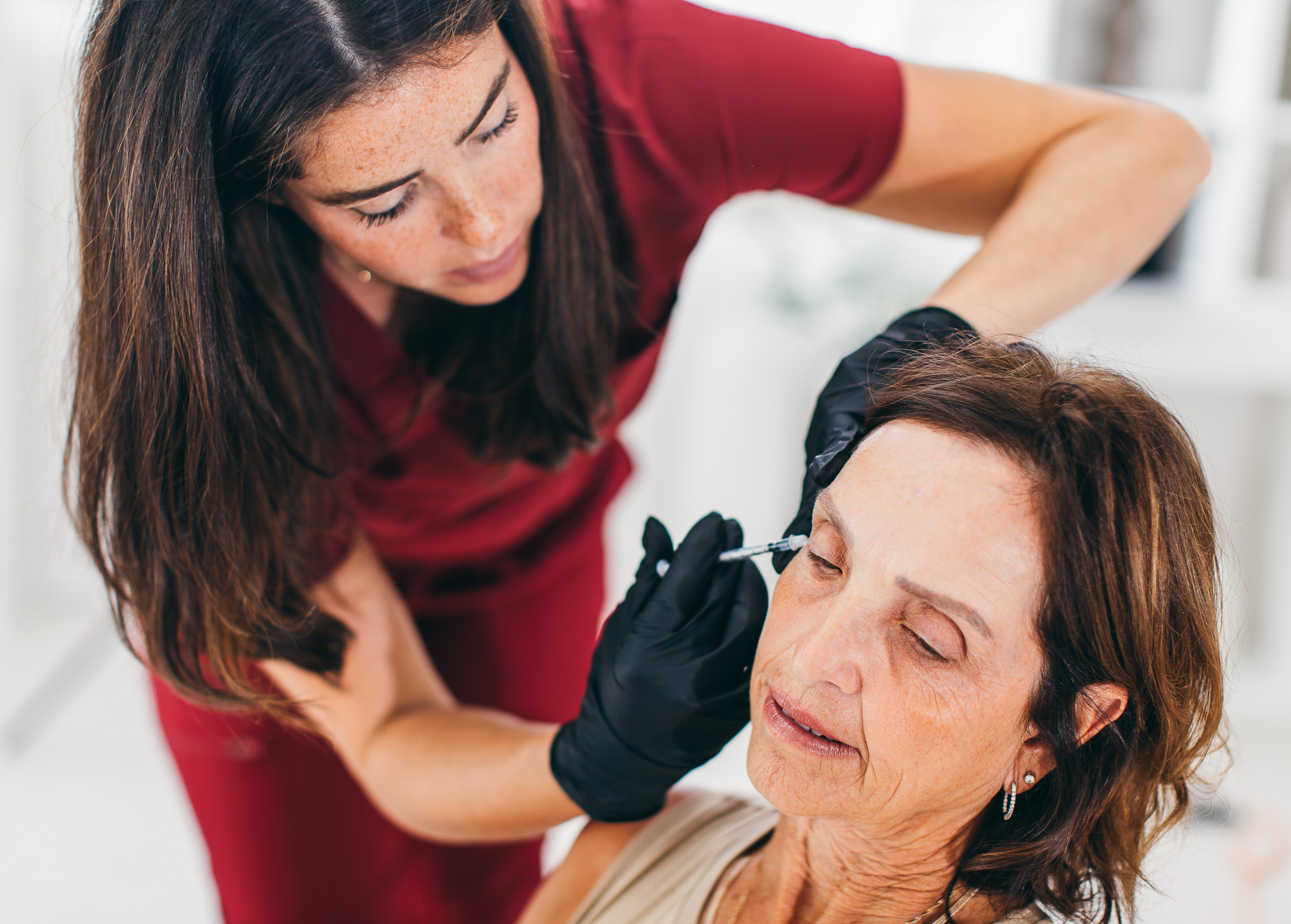 Jess, RN, performing a safe Botox injection on a female client at Face Forward Medical Aesthetics in Etobicoke, Toronto.